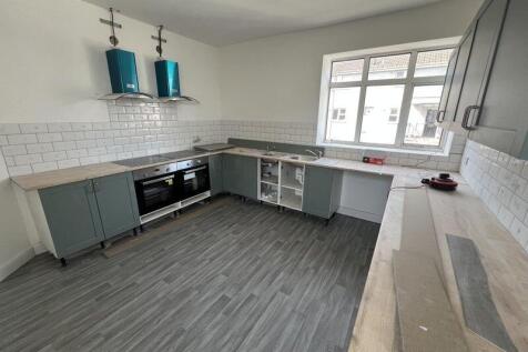 Bright and spacious kitchen featuring modern ca...