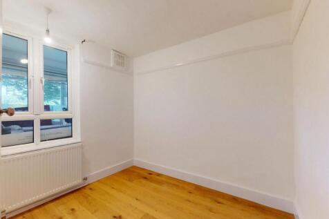 A bright and tidy bedroom with ample natural li...