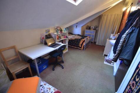 Cozy attic single bedroom with sloped ceiling, ...