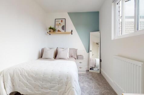 A bright and inviting double bedroom featuring ...