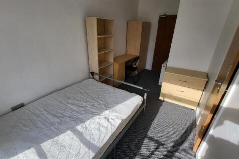 Bright, simply furnished bedroom with a single ...