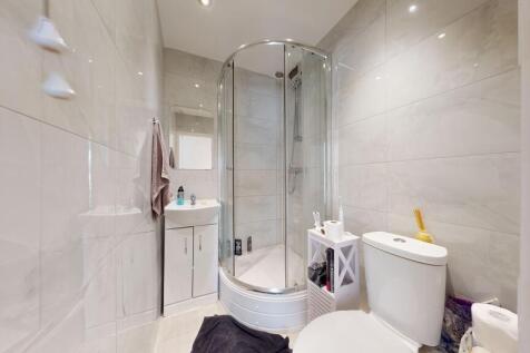 Modern bathroom with sleek marble-effect tiling...