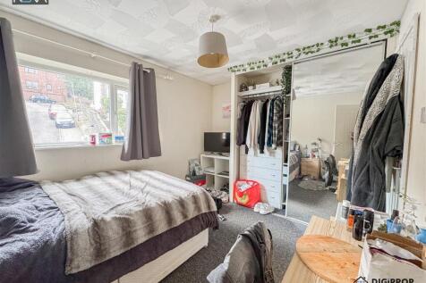 Bright bedroom with ample storage and large bed...