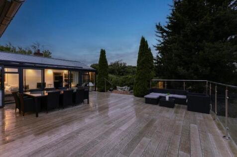 Terrace at dusk with the Sun Room as backdrop