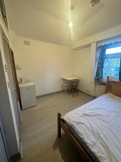 Bright double bedroom with desk and mini-fridge...