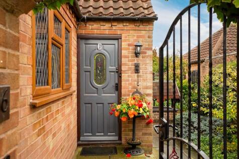 Set behind wrought iron gates