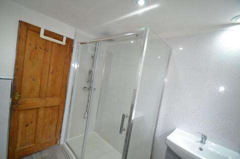 Modern bathroom featuring a walk-in shower encl...
