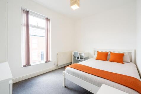 Bright and welcoming double bedroom featuring a...