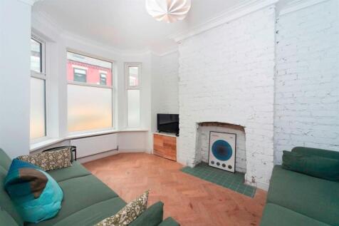 Bright living room with bay window and period f...