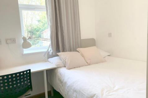 A bright and cozy double bedroom featuring a co...