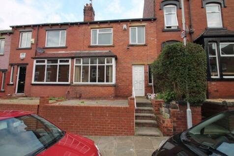 A charming red-brick house front with well-main...