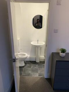 Pristine modern cloakroom with stylish tiling...