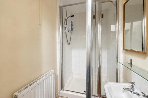 Bright bathroom with walk-in shower and mirror...