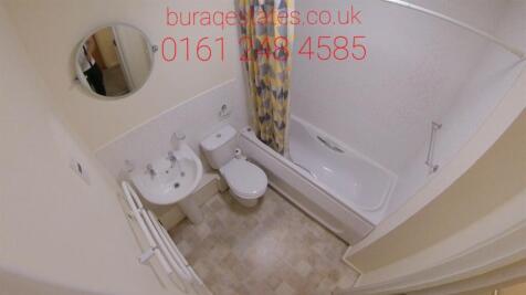 Compact, well-kept bathroom with a clean white ...