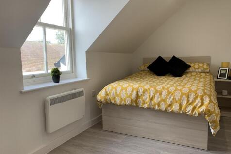Bright bedroom with large window and comfy bed...