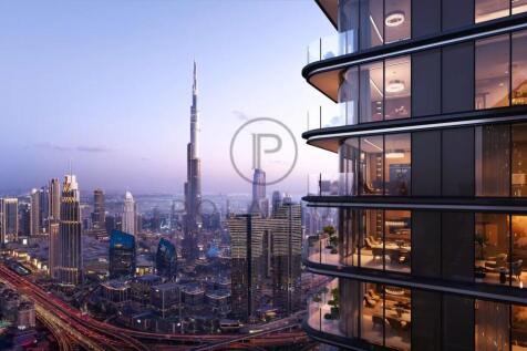 A modern cityscape at dusk with a prominent skyscr