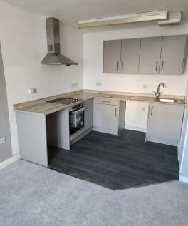 Modern kitchen with sleek grey cabinets...