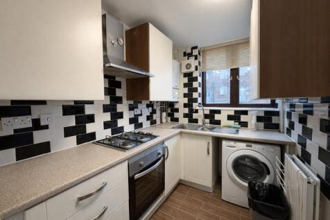 Bright, modern galley kitchen with a gas hob an...
