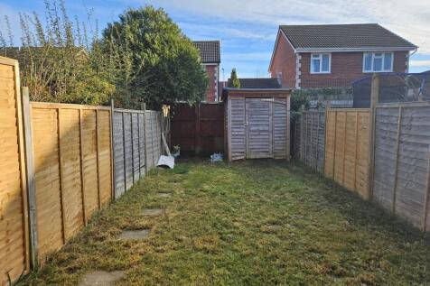 Private rear garden with a lawn, timber shed an...