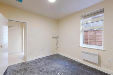 Neat single bedroom with neutral decor, carpete...