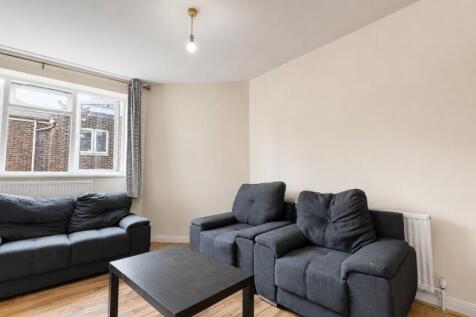 Bright living room with comfortable grey sofas....