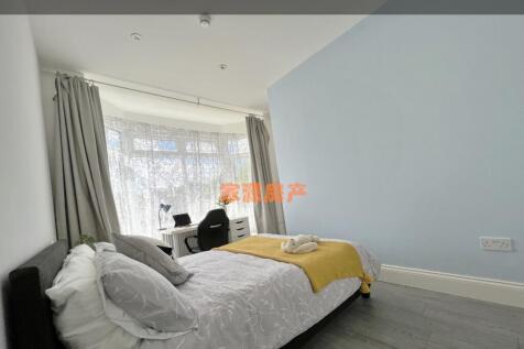 Bright and airy master bedroom featuring a comf...