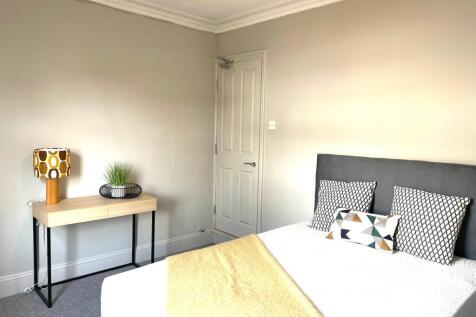 A bright and modern double bedroom featuring a ...