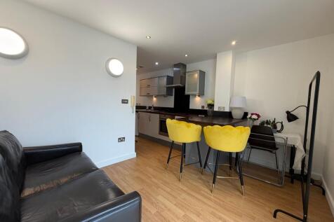 Contemporary open-plan living area with a sleek...
