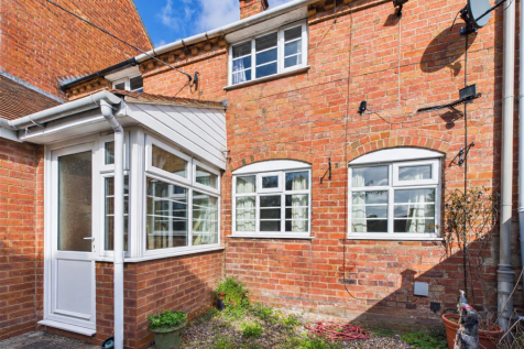 Sunlit Red-Brick House Exterior.png