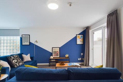 A spacious and modern living room featuring a v...