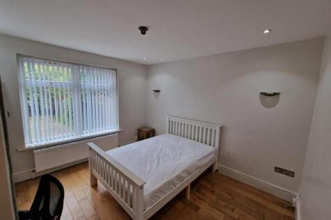 Bright, tidy bedroom with a white double bed, w...