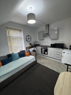 Bright open-plan living area with a modern fitt...