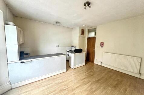 Spacious open kitchen with wood-effect flooring...