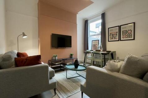 A spacious and stylish living room with modern ...