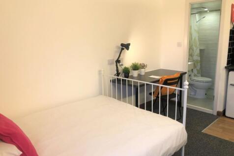 A cozy and well-kept single bedroom featuring a...