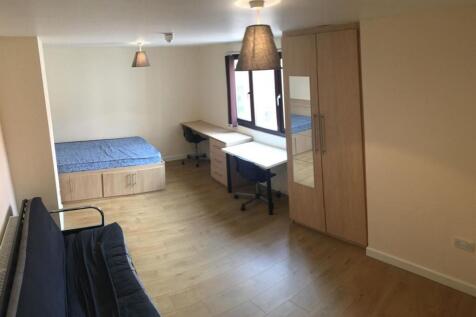 Spacious bedroom with ample desk and storage sp...