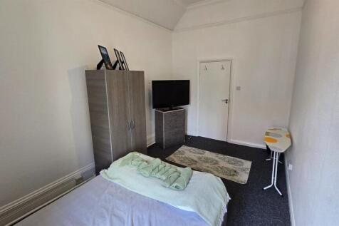 Cozy double bedroom with wardrobe and TV...