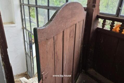 Wooden door partially open revealing outdoor stairs