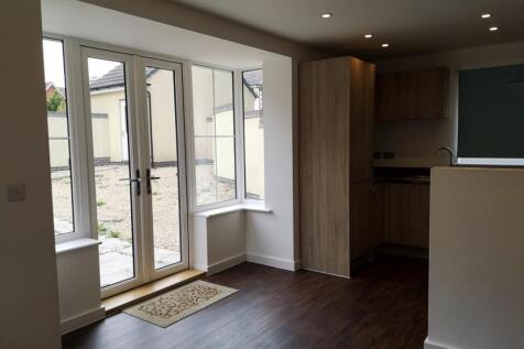 A modern and well-lit kitchen with ample space ...