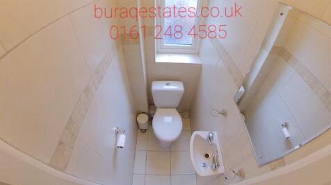 Bright white bathroom with modern tiling, a WC,...