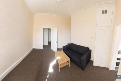 Bright living area with comfy sofa and storage...