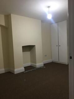 Bright, neutral bedroom with fitted corner ward...