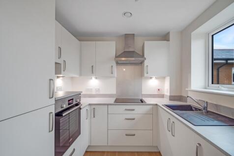 a kitchen with white cabinets