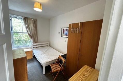 Bright bedroom with ample storage and large win...