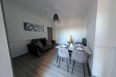 Bright, modern living and dining area with cont...