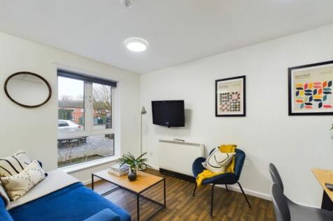 A spacious and stylish modern living room featu...