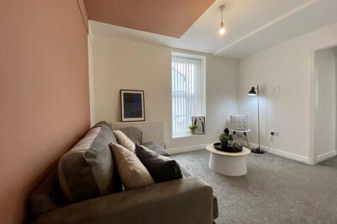 A bright and inviting living room with a cozy s...