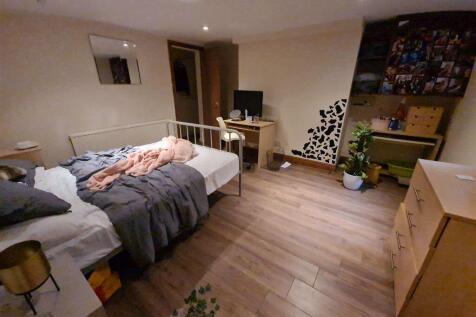 Cozy single bedroom featuring a comfortable bed...