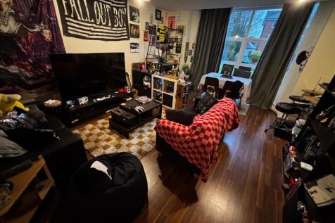 Bright, characterful living room with large win...