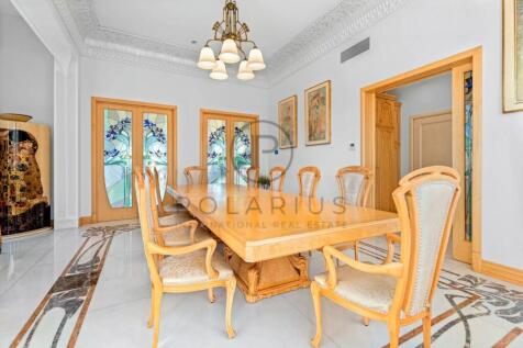 Elegant dining room with a long wooden table, surr